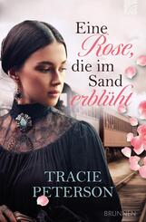 Eine Rose, die im Sand erbl&uuml;ht
